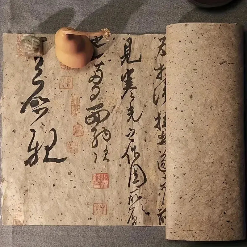 Aged, textured Pirate scroll paper with black calligraphy and red seals, partially rolled, beside a small gourd.