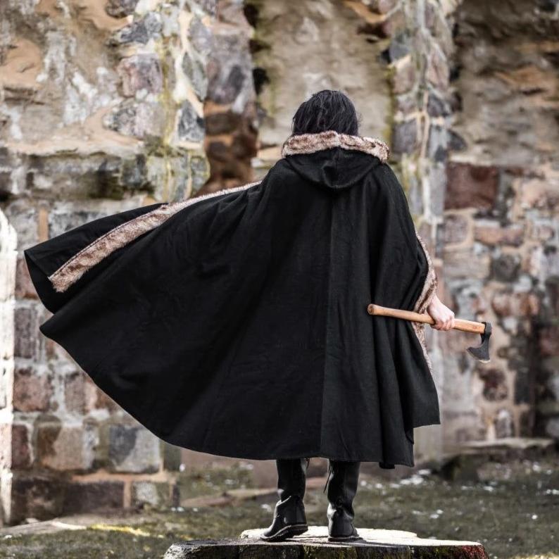 Black hooded Pirate cape made of wool blend with faux fur trim, worn by a person holding an axe.