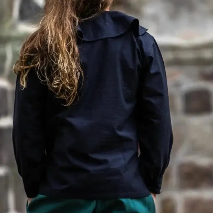 Black cotton Pirate shirt with wide round collar and wooden cuff buttons, seen from the back.