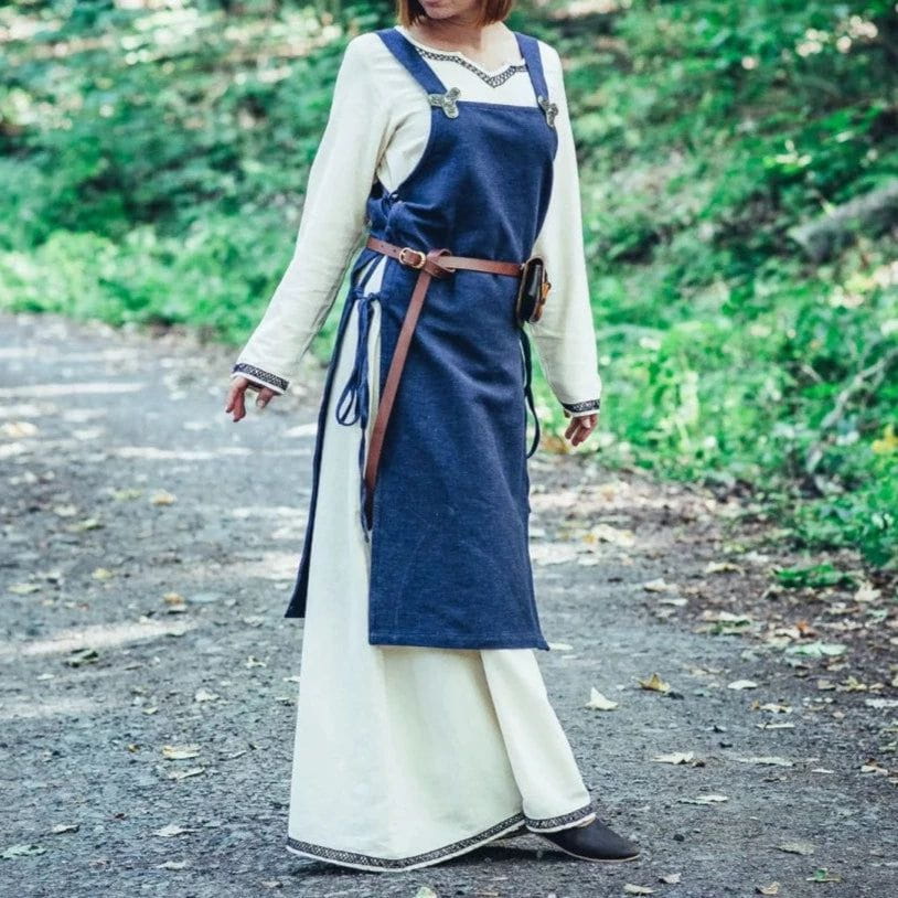 Blue cotton Pirate overdress with wide straps and side ties, layered over a cream underdress.