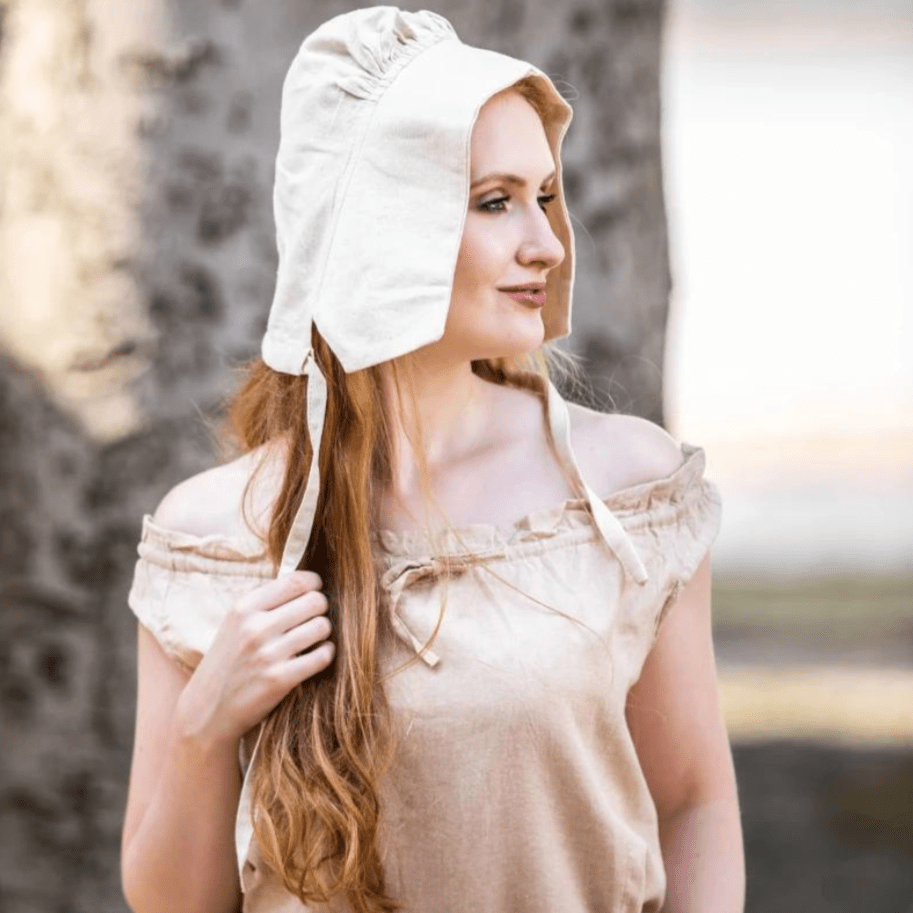 Natural off-white cotton Pirate coif on a woman, featuring a gathered crown and ties.
