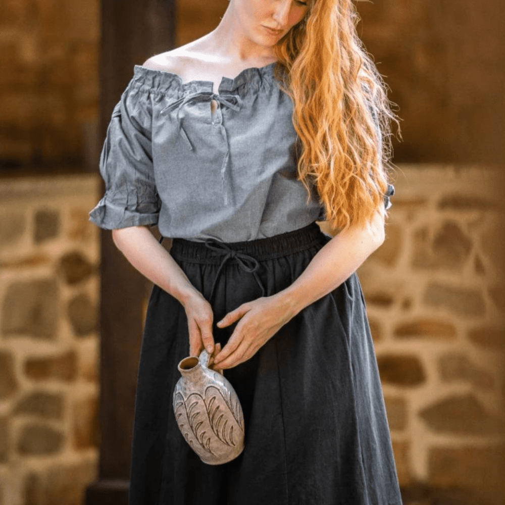 Grey-blue Pirate blouse with short sleeves, cord lacing, and off-shoulder style, made from natural cotton.