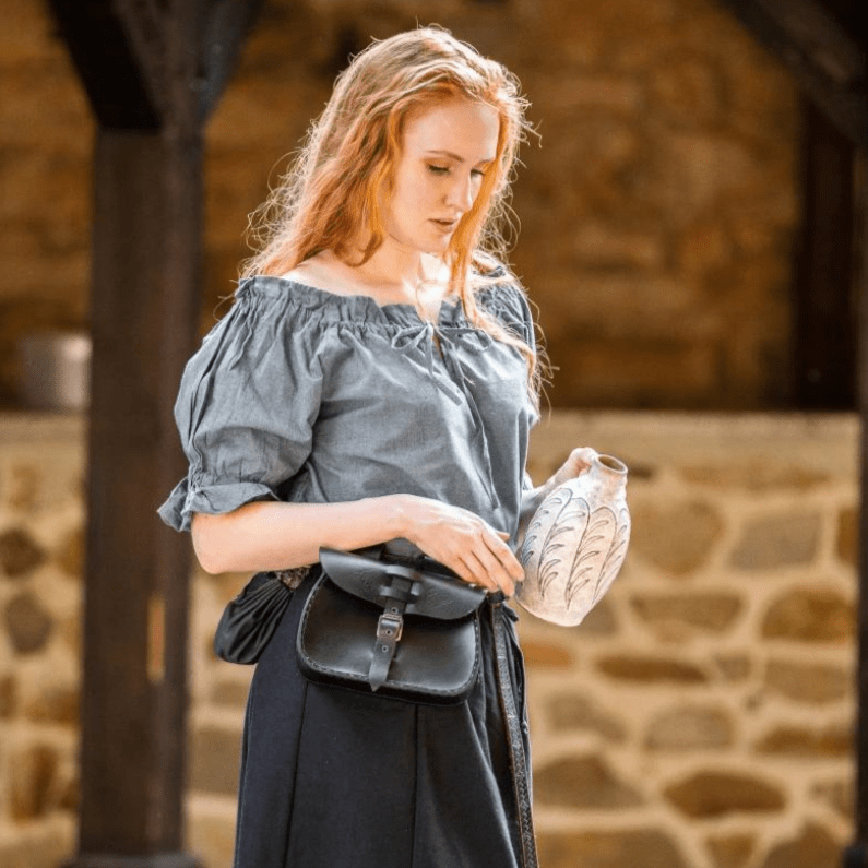 Grey-blue Pirate blouse with short sleeves, cord lacing, and off-shoulder style, worn with a black belt pouch.