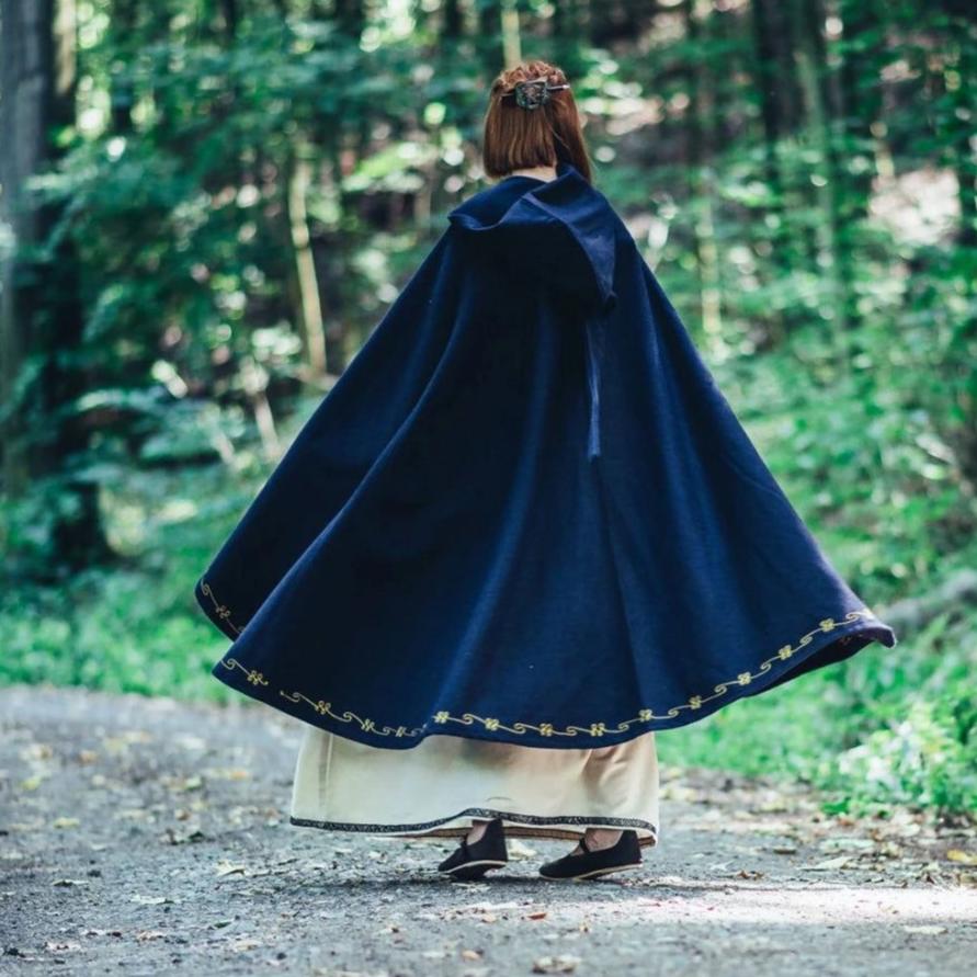Dark blue wool blend hooded Pirate cloak with gold hand-stitched embroidery, worn from behind in a forest.