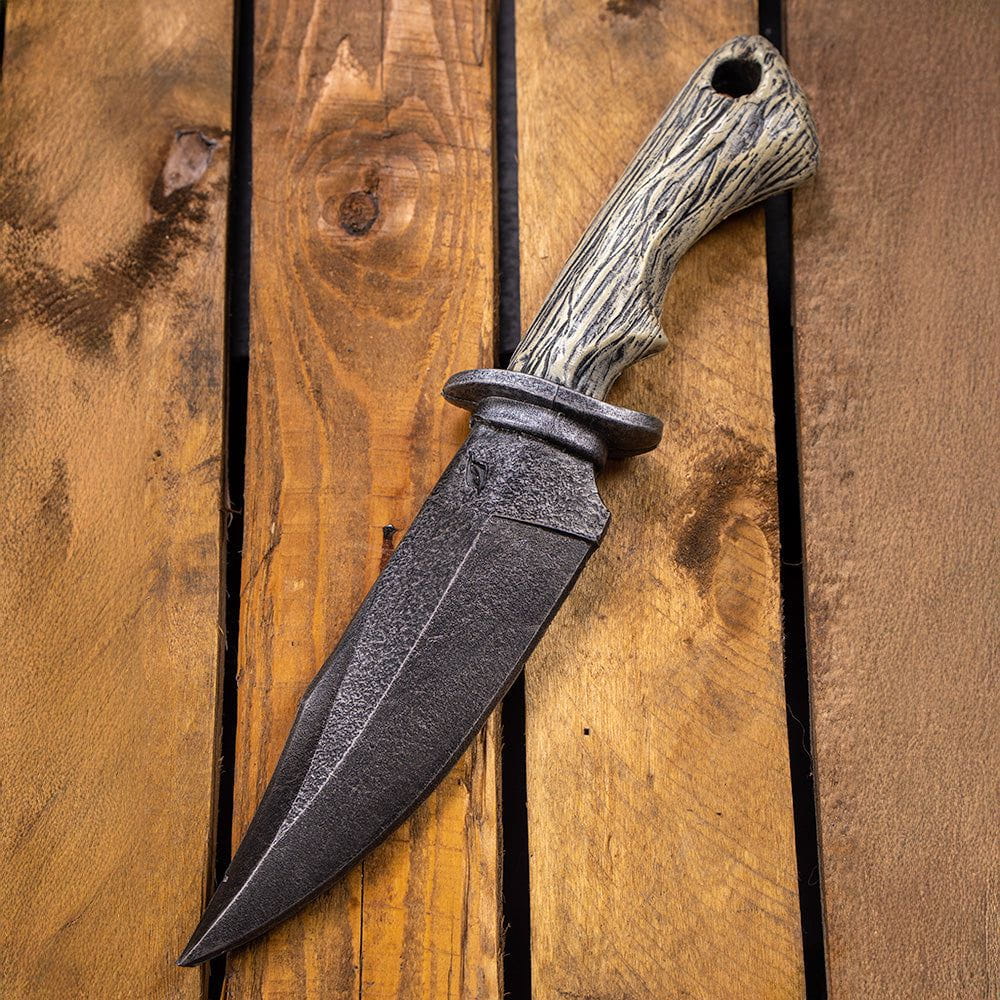 LARP Pirate Combat Knife with dark foam blade and faux bone handle on wooden planks.