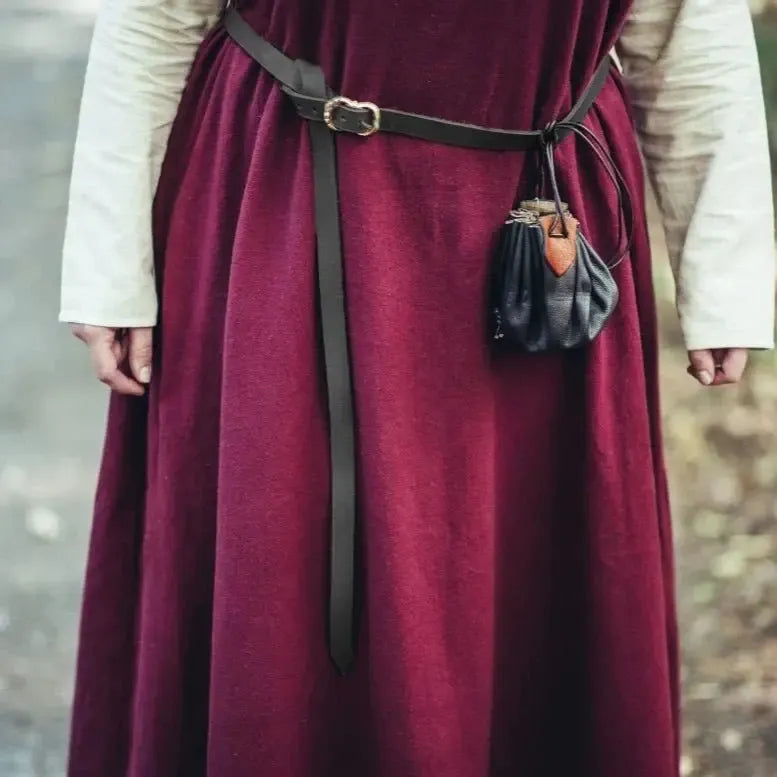 Narrow dark brown genuine leather Pirate belt with brass-coated buckle, worn over a maroon dress with a small pouch.