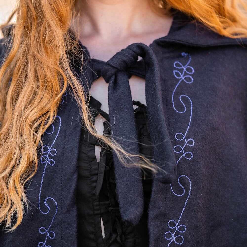 Dark wool Pirate cloak with blue hand-stitched embroidery and front string closure.