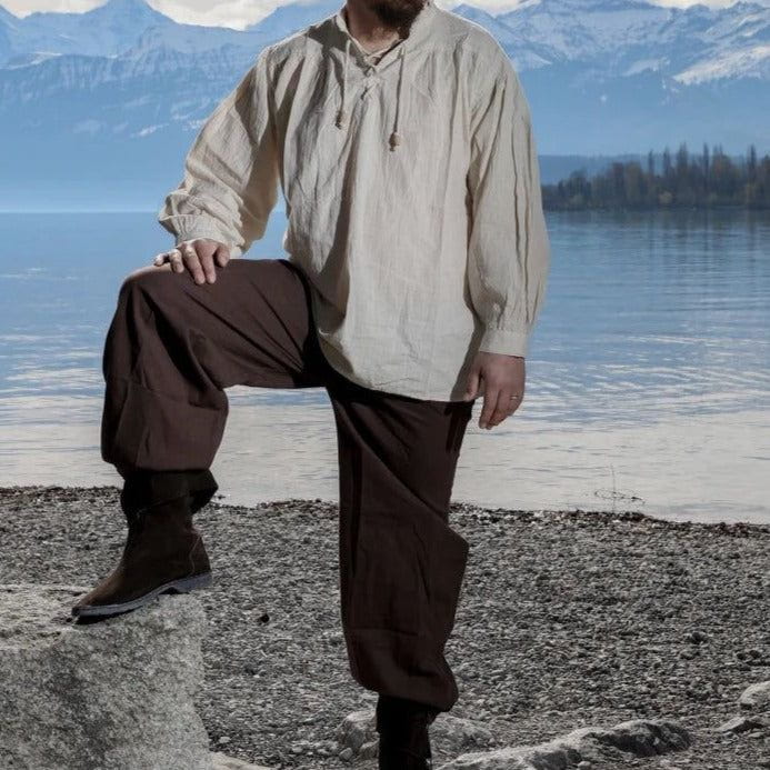 Brown loose-fit Pirate pants with buttoned ankle cuffs and a lace-up front, made of natural cotton.