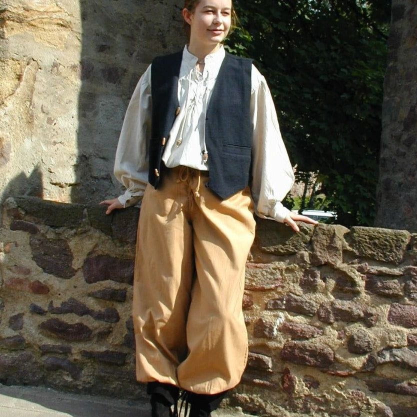 Tan loose-fit Pirate pants with lace-up front and buttoned ankle cuffs, made from natural cotton.