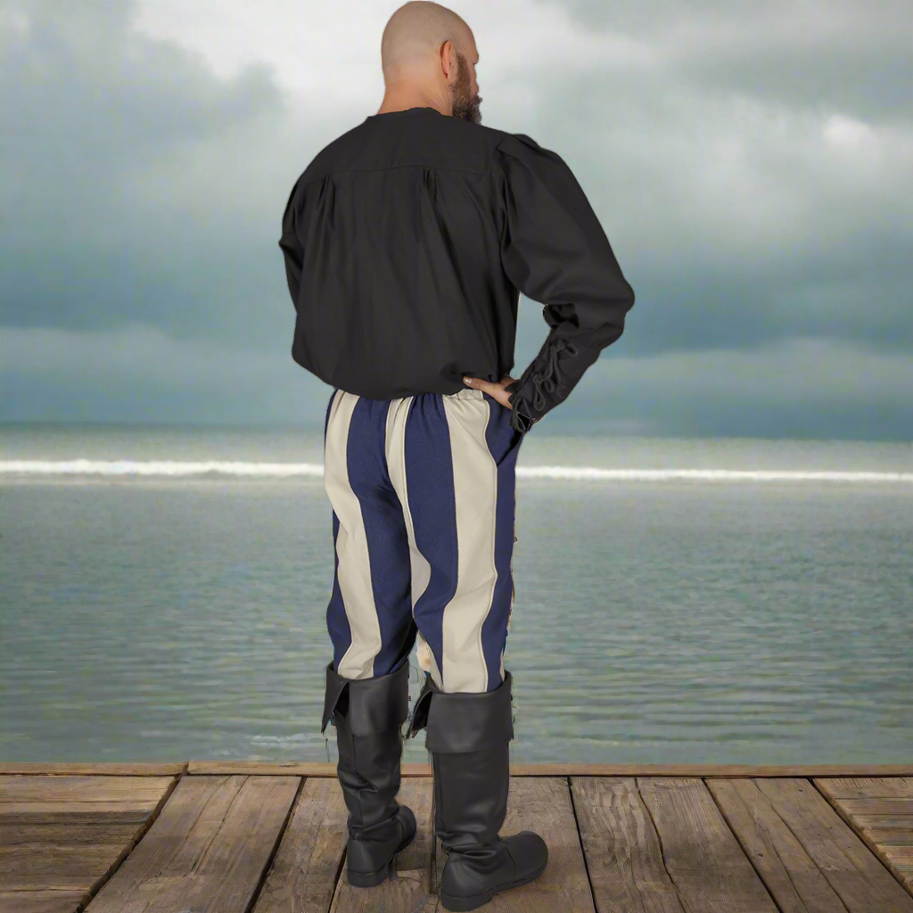 rear view of man wearing striped pants, pirate boots and a blue waistcoat