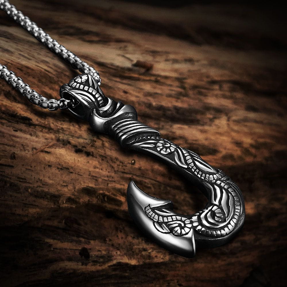 Silver metal Pirate fish hook pendant with mythical carvings on a sturdy chain.