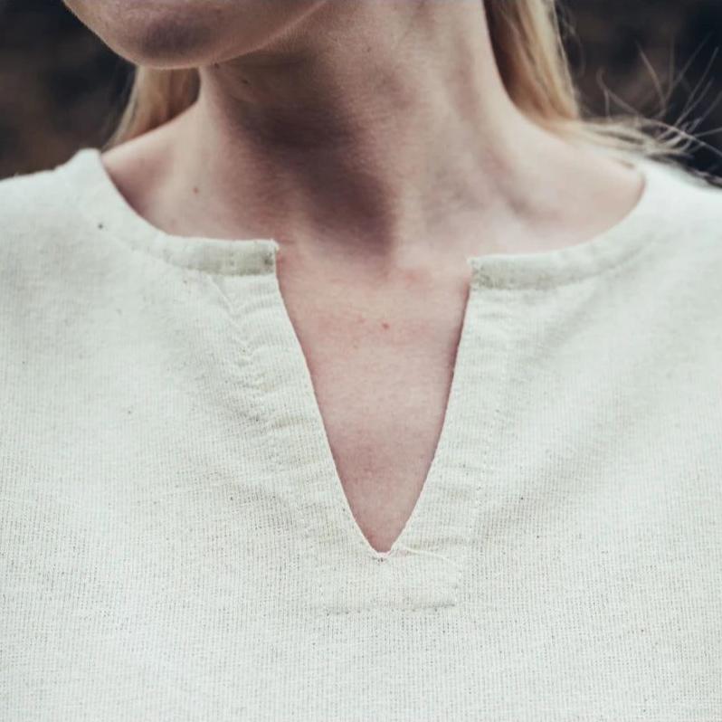 Close-up of a natural cotton Pirate's underdress, showing the V-neck and textured fabric.