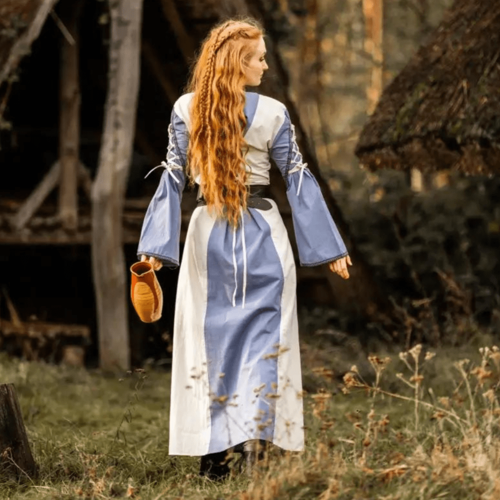 Natural and blue Pirate gown with laced cuffs, V-neck, and open trumpet sleeves, worn by a woman with long red hair.