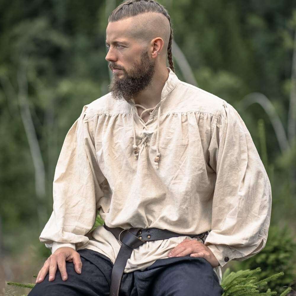 Natural white pirate shirt with lace-up collar, loose fit, and full sleeves, worn by a man with a beard.