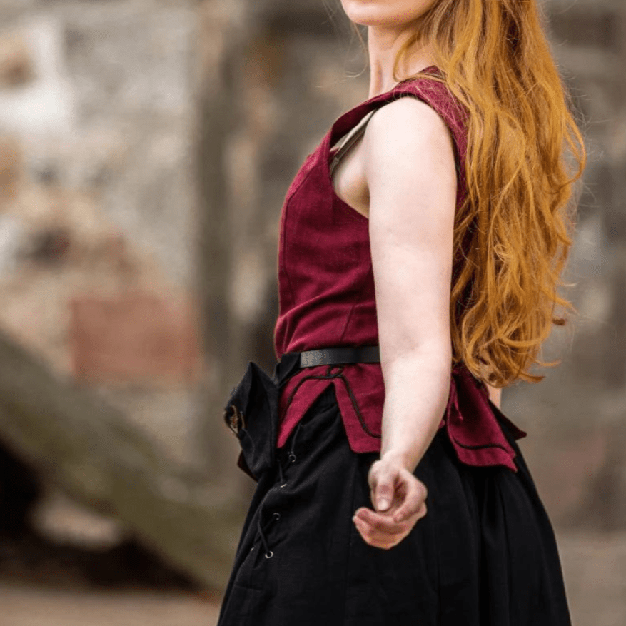 Red cotton Pirate wench bodice with black trim and lacing, worn by a woman with long red hair.