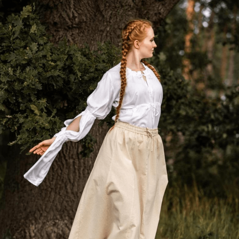 White long-sleeve Pirate blouse with ruched sleeves and adjustable waist lacing on a woman.