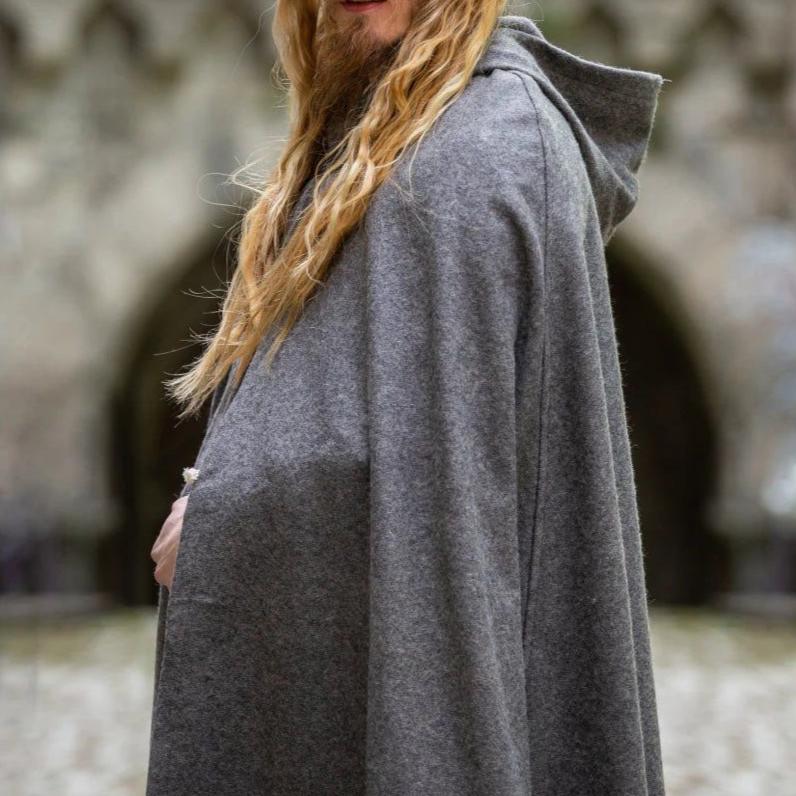 Gray wool Pirate cloak with a hood and metal wolf clasp, worn by a person with long blonde hair.