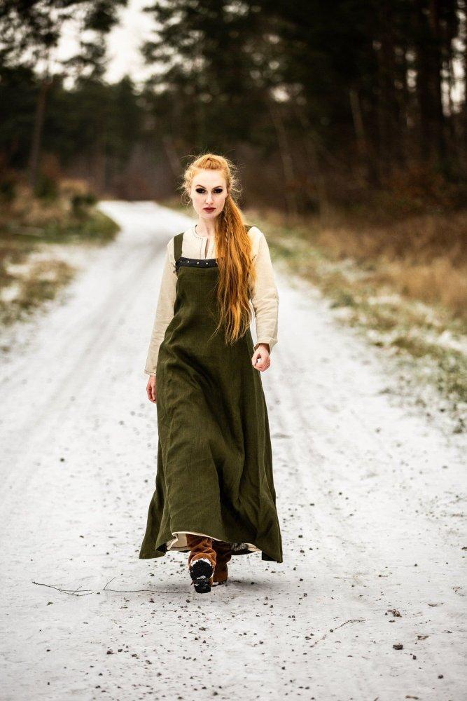 Green linen pirate over dress worn over an underdress, side view