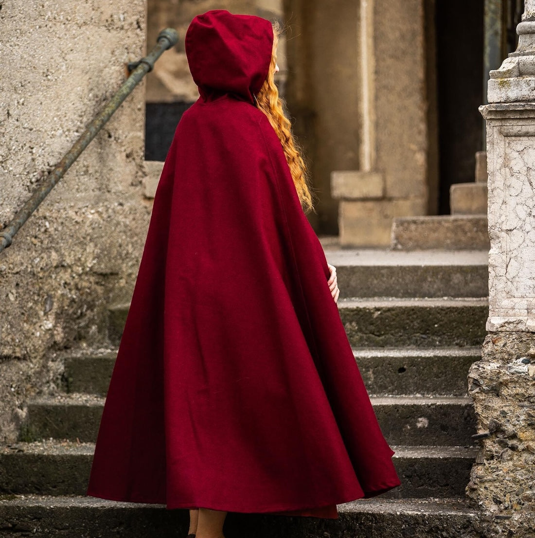 Red wool pirate cloak worn with the hood up