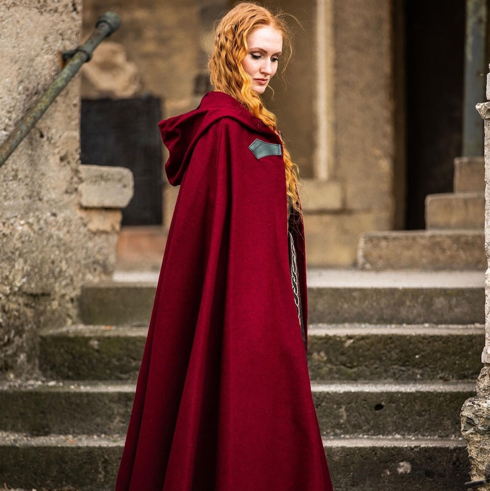 Red wool cloak laid out to show its full width