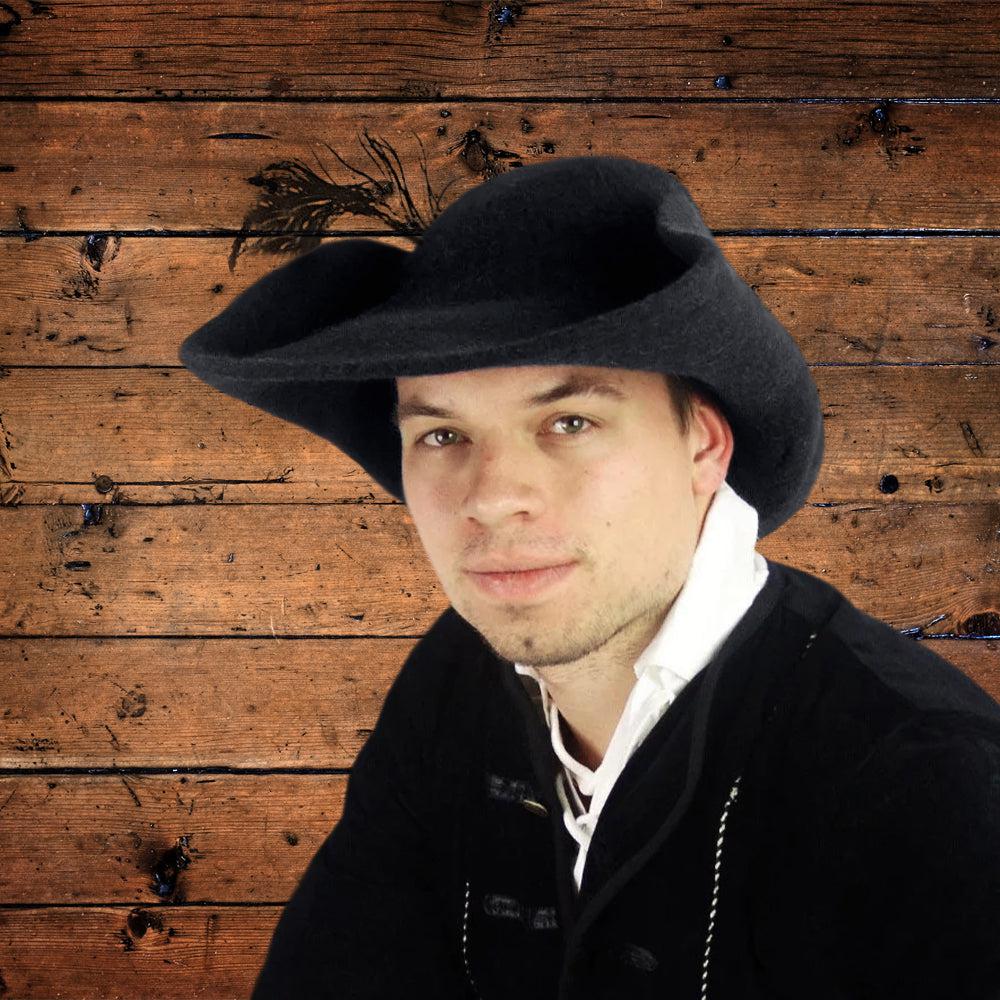 Black felted wool Pirate hat with a cocked brim and decorative feather, worn by a man.