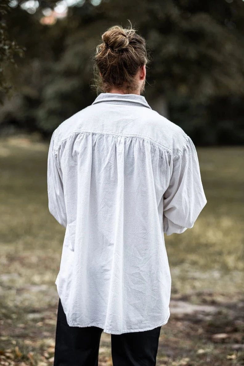 Back of a loose-fitting white cotton Pirate shirt with gathered yoke and long sleeves.