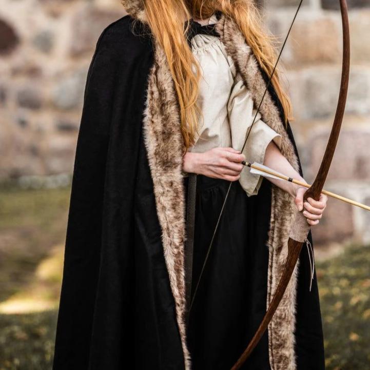 Black hooded Pirate cape made of wool blend with luxurious faux fur trim, worn by a person holding a bow.