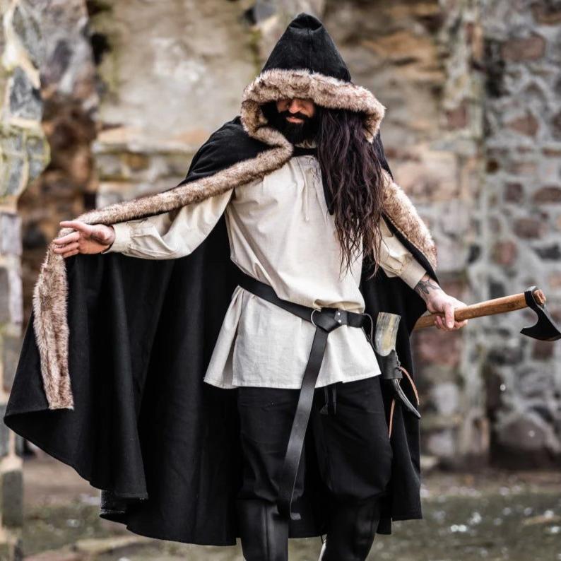 Black hooded Pirate cape made of wool with luxurious faux fur trim, worn by a man holding an axe.