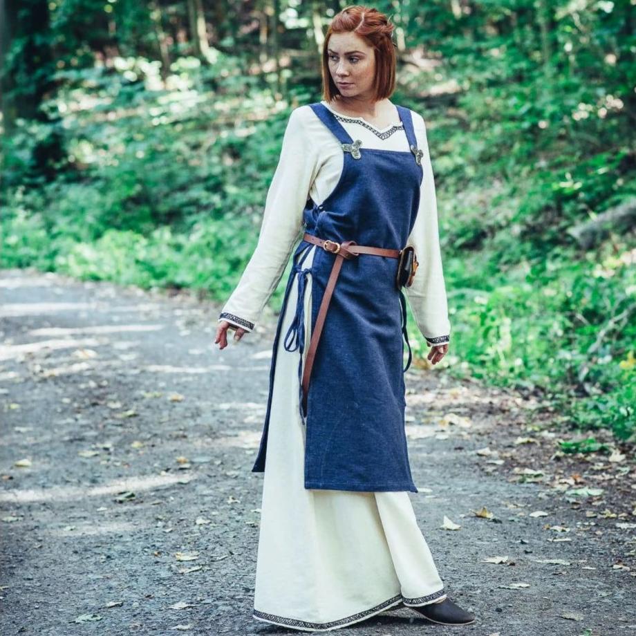 Blue cotton Pirate overdress with wide straps, side ties, worn over a cream underdress with a brown belt.