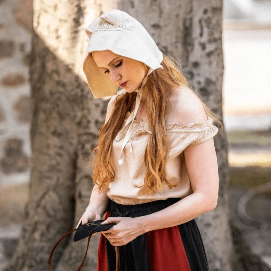Natural off-white cotton Pirate coif on a woman with long red hair, tied under her chin.
