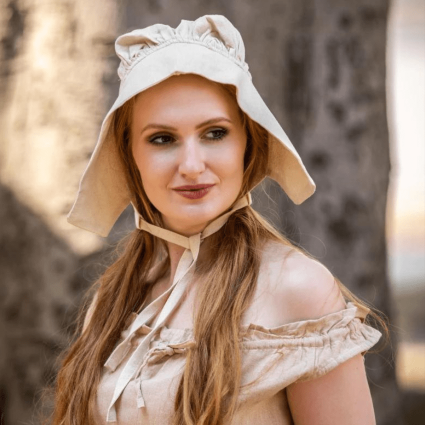Woman wearing a natural off-white cotton Pirate coif with ties, protecting her head and neck.