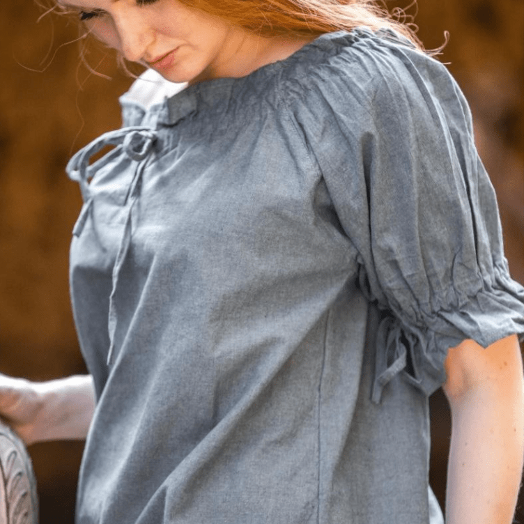 Grey-blue Pirate blouse with short puffed sleeves, cord lacing, and elastic neckline, made from natural cotton.