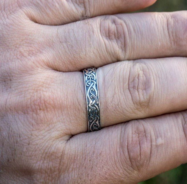 Handcrafted sterling silver Pirate ring with intricate ornamental patterns worn on a finger.