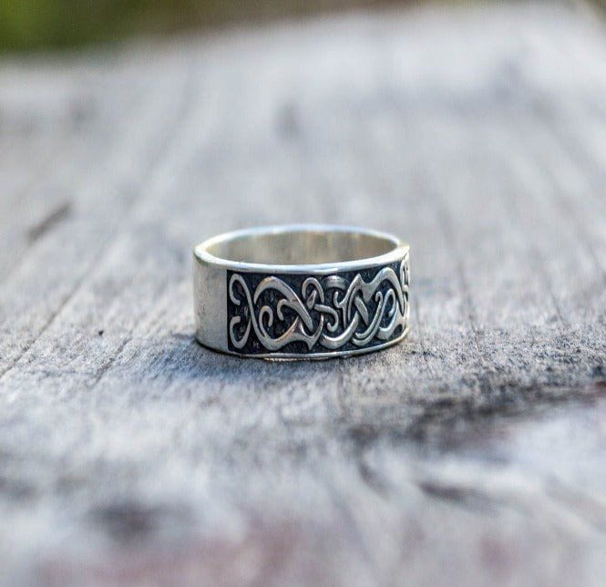 Handcrafted sterling silver Pirate ring with intricate ornamental patterns on a wooden surface.