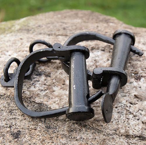 Wrought iron Pirate handcuffs with a gun-black patina, featuring hand-riveted cuffs and a working key-turned lock.