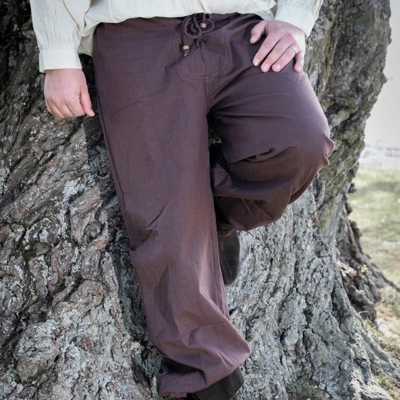 Brown loose-fit Pirate pants with lace-up front, elastic back, and buttoned ankle cuffs, made from natural cotton.