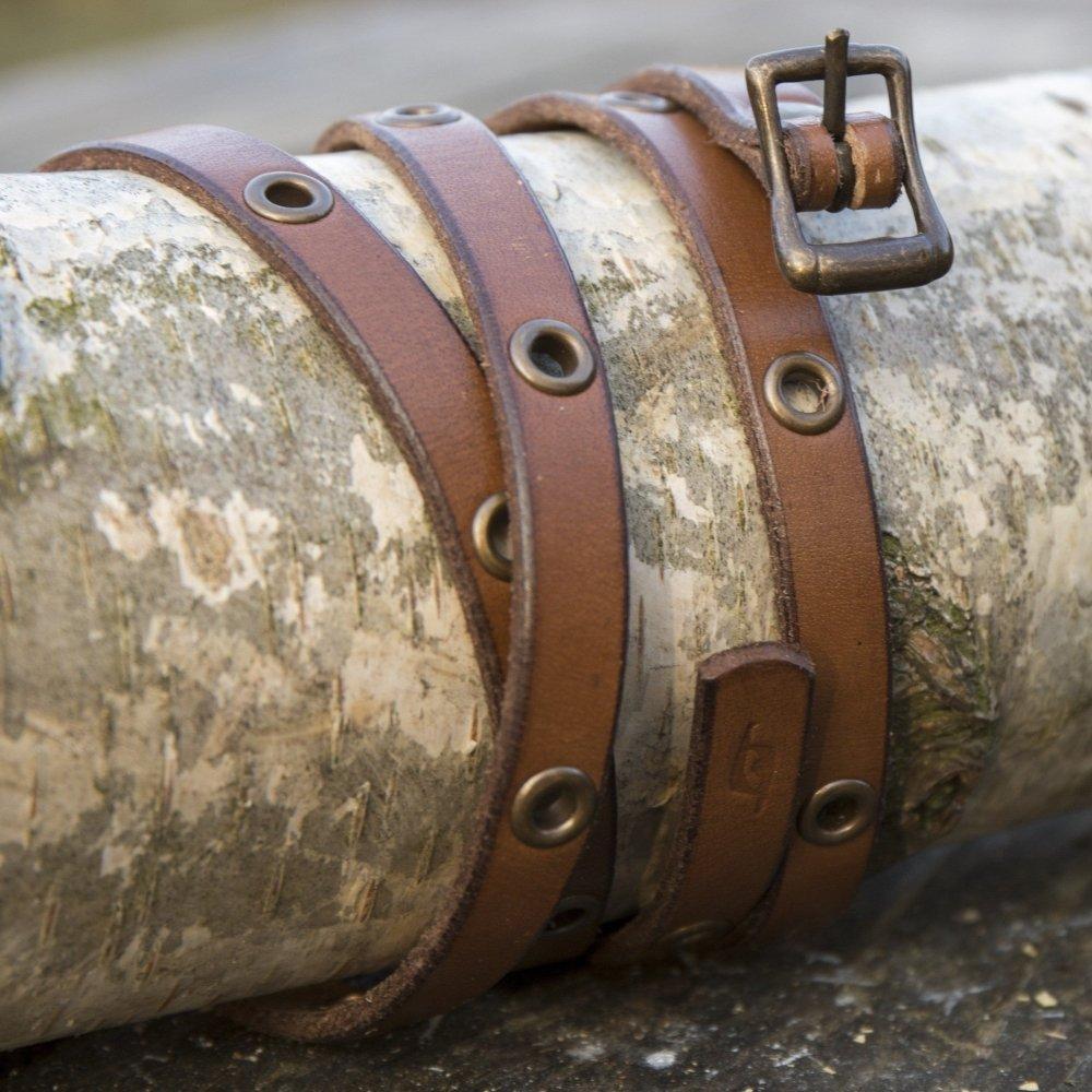 Brown genuine leather multistrap Pirate bracelet with brass hardware and adjustable buckle closure.
