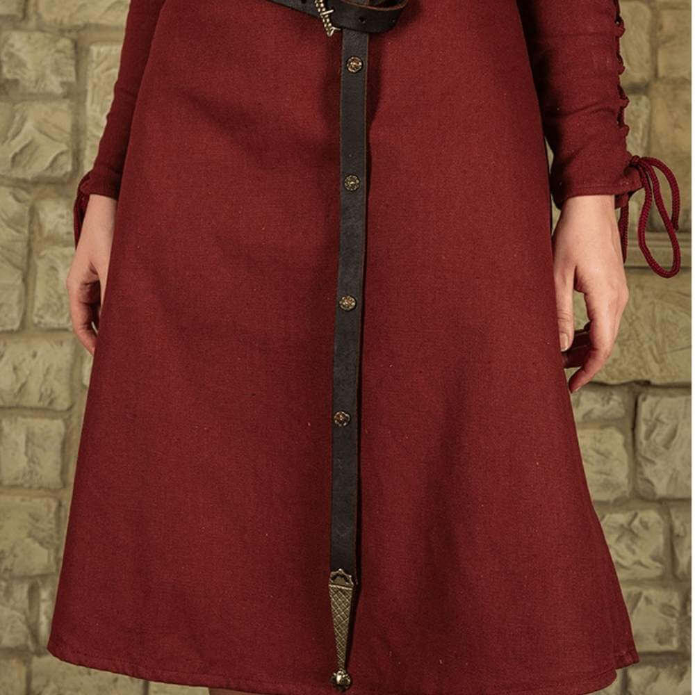 Pirate Lady's brown leather belt with brass buckle, rose details, and decorative tip over a red dress.