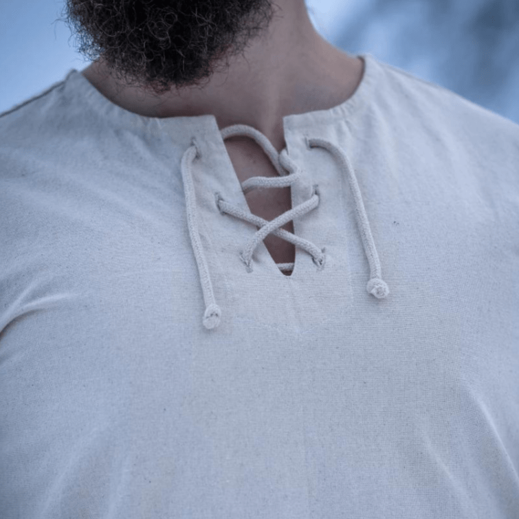 Natural cotton Pirate tunic with a lace-up collar, shown on a person with a beard.