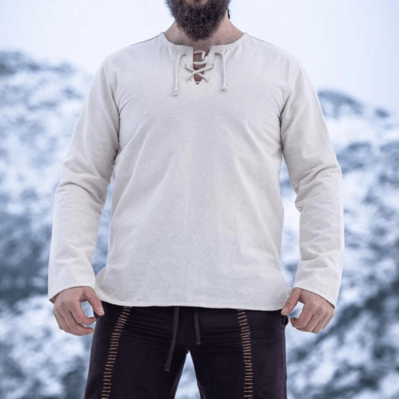 Natural cotton long-sleeve Pirate tunic with lace-up collar, shown on a person against a snowy background.
