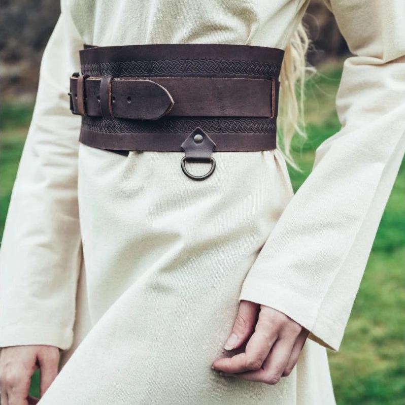 Natural cotton Pirate underdress with long sleeves, cinched by a wide, dark brown leather belt with a metal D-ring.