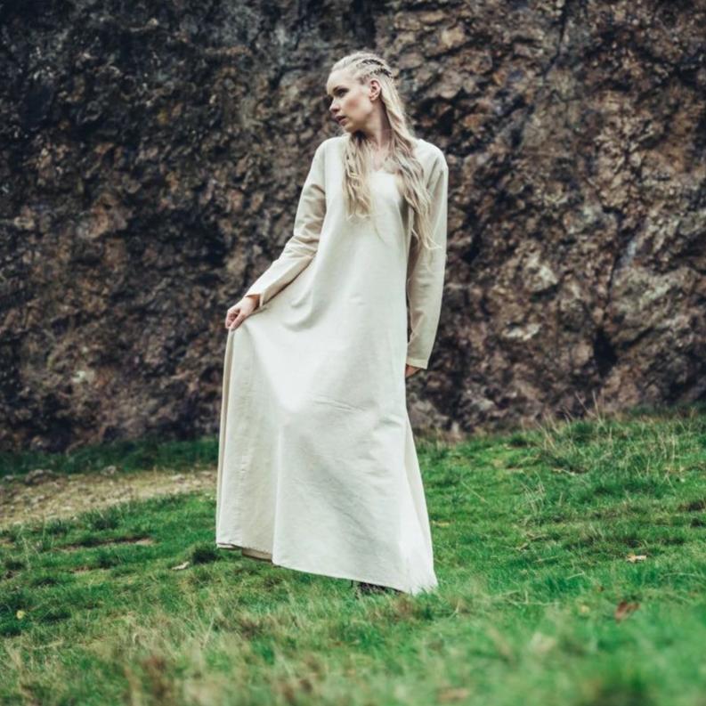 Natural cotton Pirate's underdress, long-sleeved and floor-length, worn by a blonde woman outdoors.