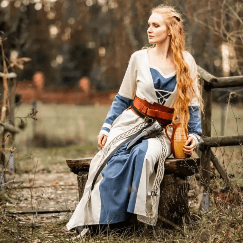 Natural and blue cotton Pirate dress with long sleeves, laced front, and brown belt.