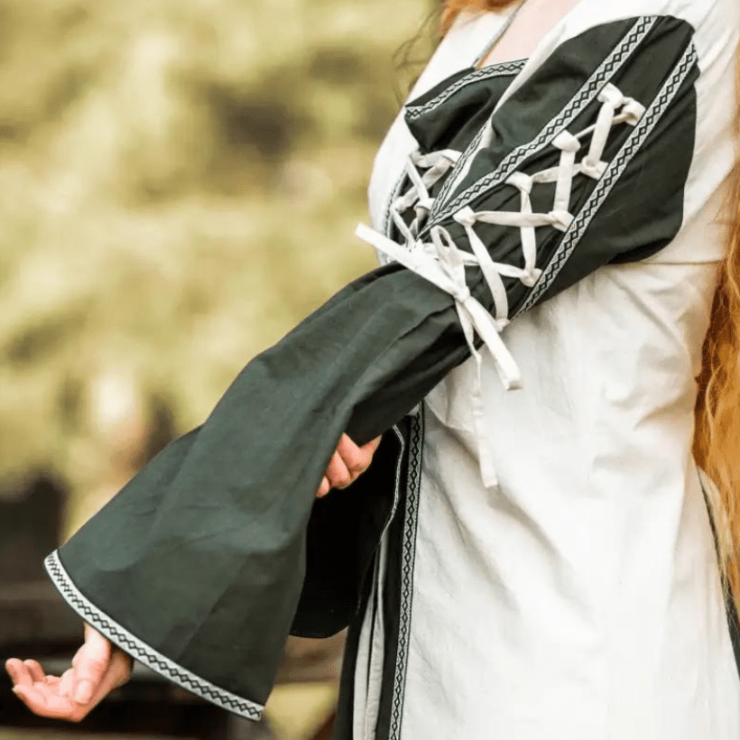 Pirate gown: natural and green laced cotton dress with trumpet sleeves and floral border.
