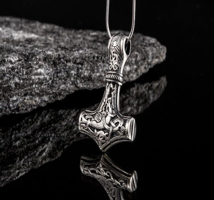 Sterling silver Pirate Thor's Hammer pendant with intricate Mammen-style design on a dark, reflective surface.