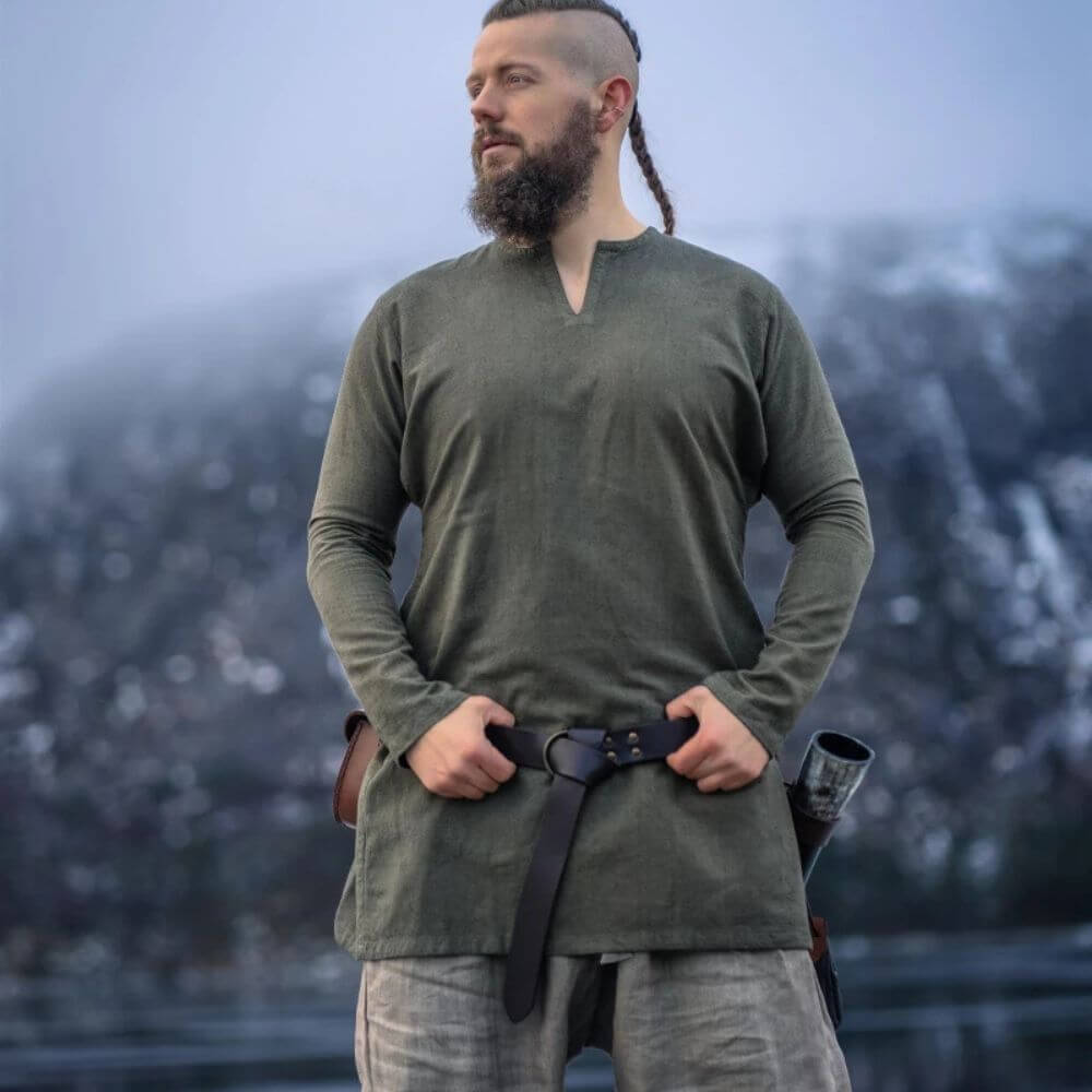 Olive green linen Pirate tunic, thigh-length with a classic cut neckline, worn by a man.