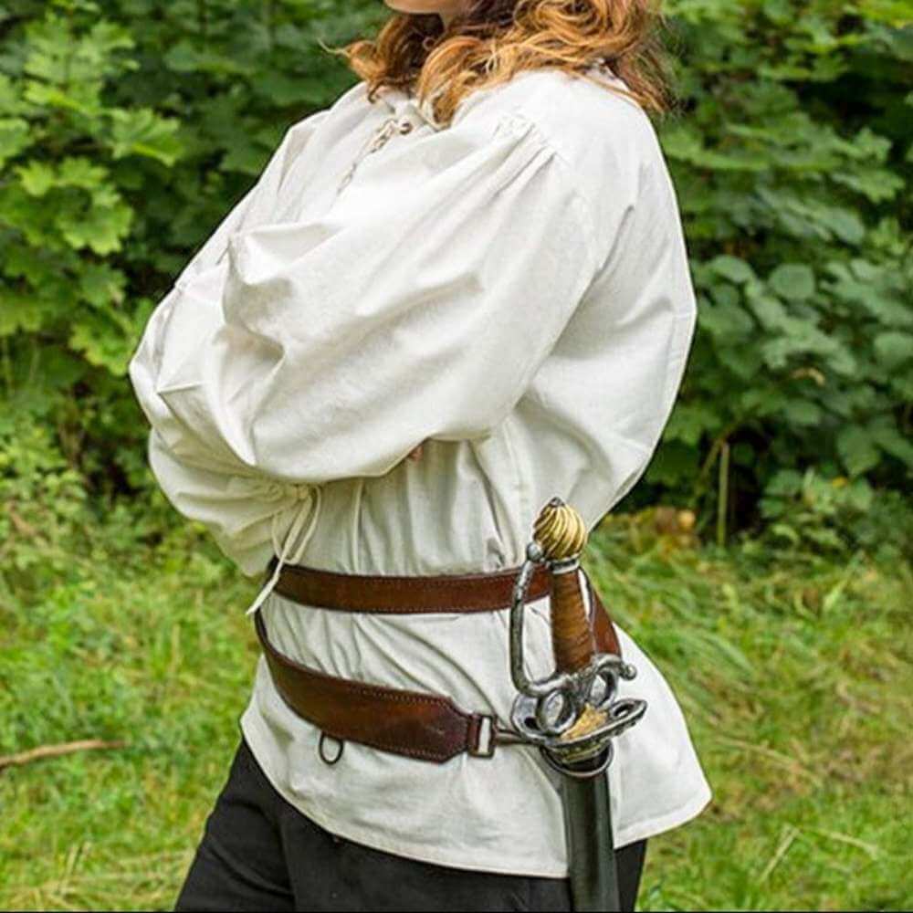Person wearing a Pirate Sword Belt in Black or Brown Leather with a sheathed sword, standing outdoors.
