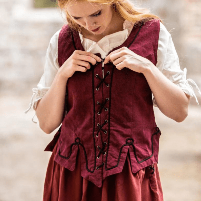 Red cotton Pirate bodice with front lacing and embroidered details, worn over a white blouse.