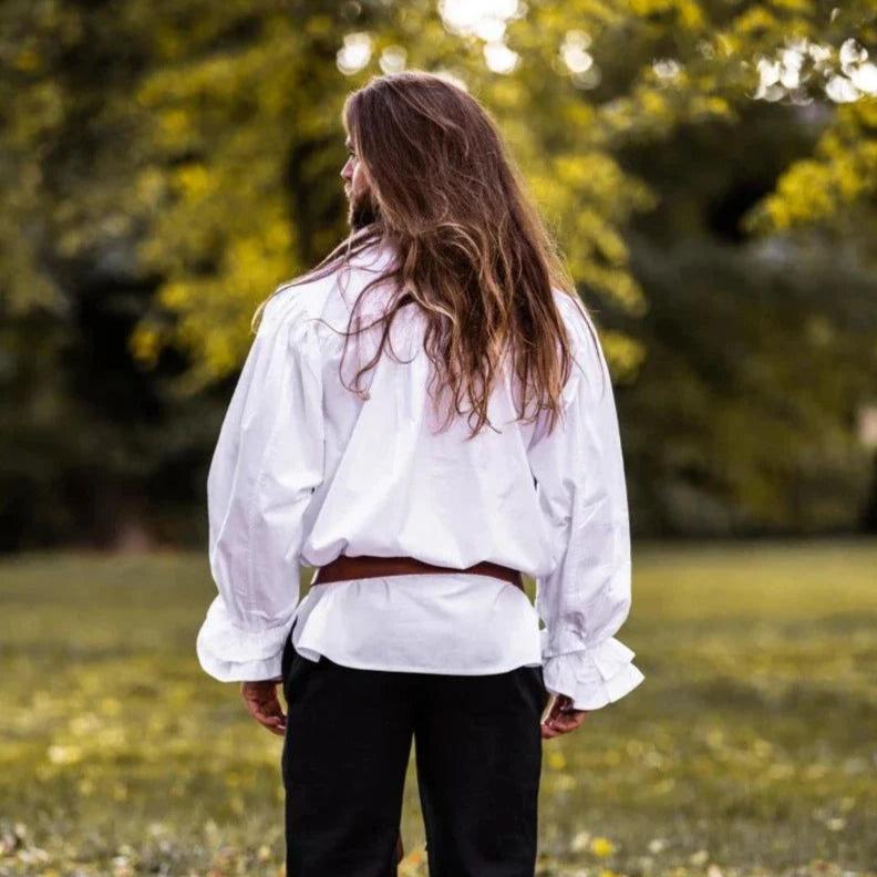 White cotton Pirate shirt with ruffles, puffed sleeves, and a brown belt, worn by a person with long hair.