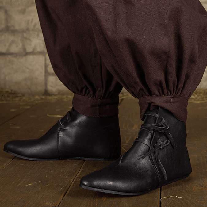 Black leather pirate ankle boots with four leather ties at the ankle